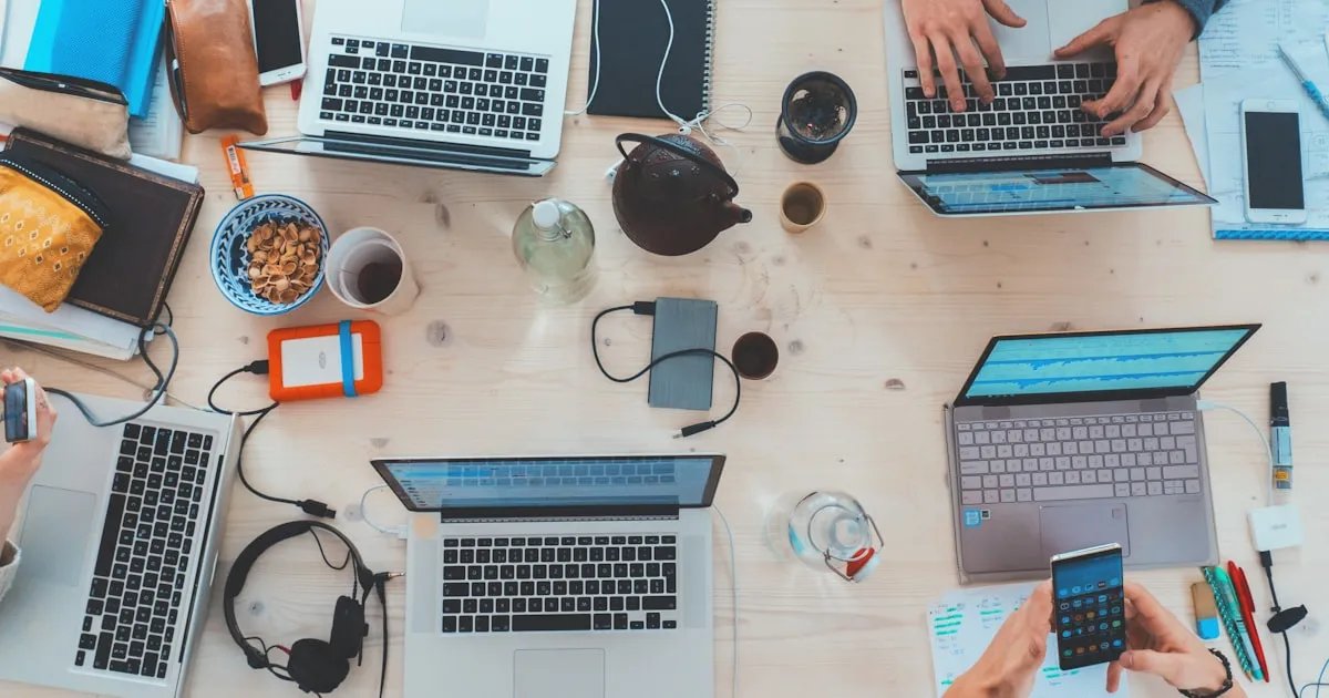 Team working on laptops at a modern office desk